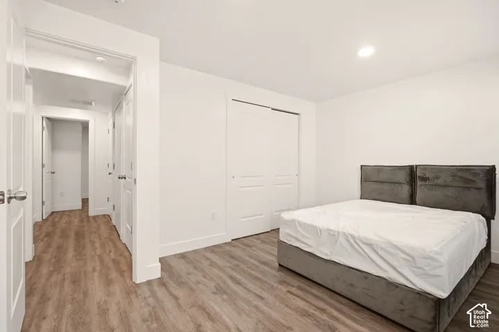 Wood-finish flooring throughout, white walls, and bright overhead lighting