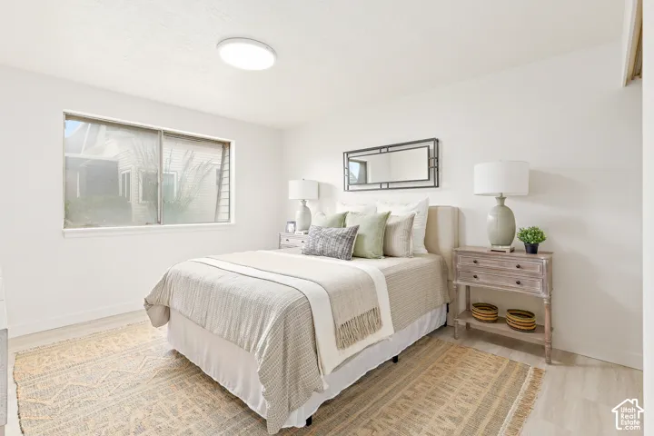 Recessed window with white trim, light wood-finish flooring, and a flush mount ceiling light fixture