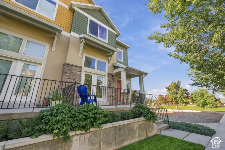 Multi-level exterior with varied siding finishes and brick accents
