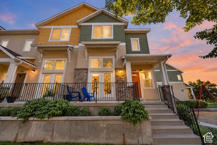 Multi-level townhome with a varied facade featuring stucco and horizontal siding