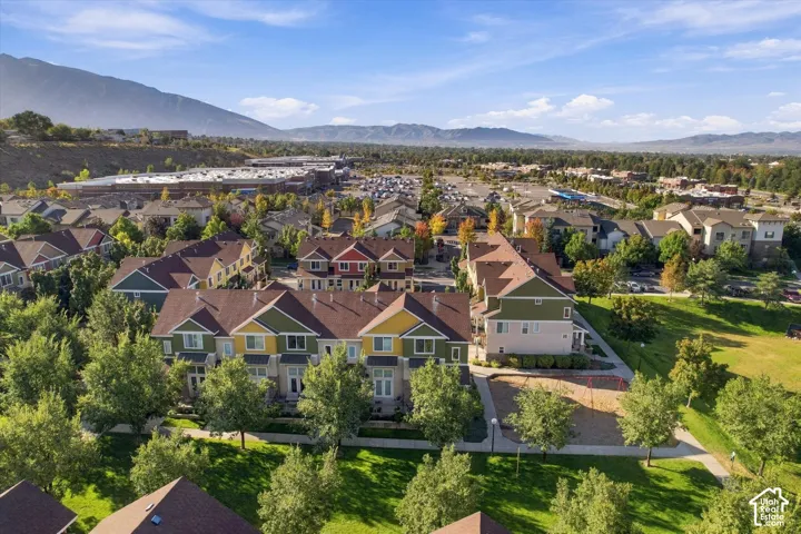 Mountain-backed community featuring multi-story residences, mature trees, and nearby recreational green spaces