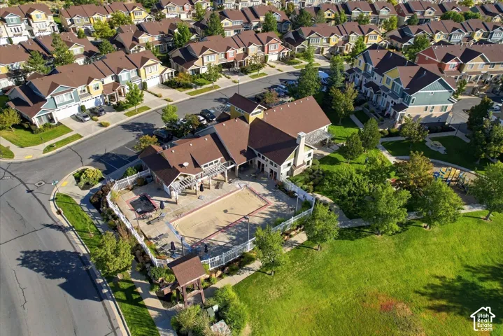 Expansive community green space, adjacent to a community building with a covered patio