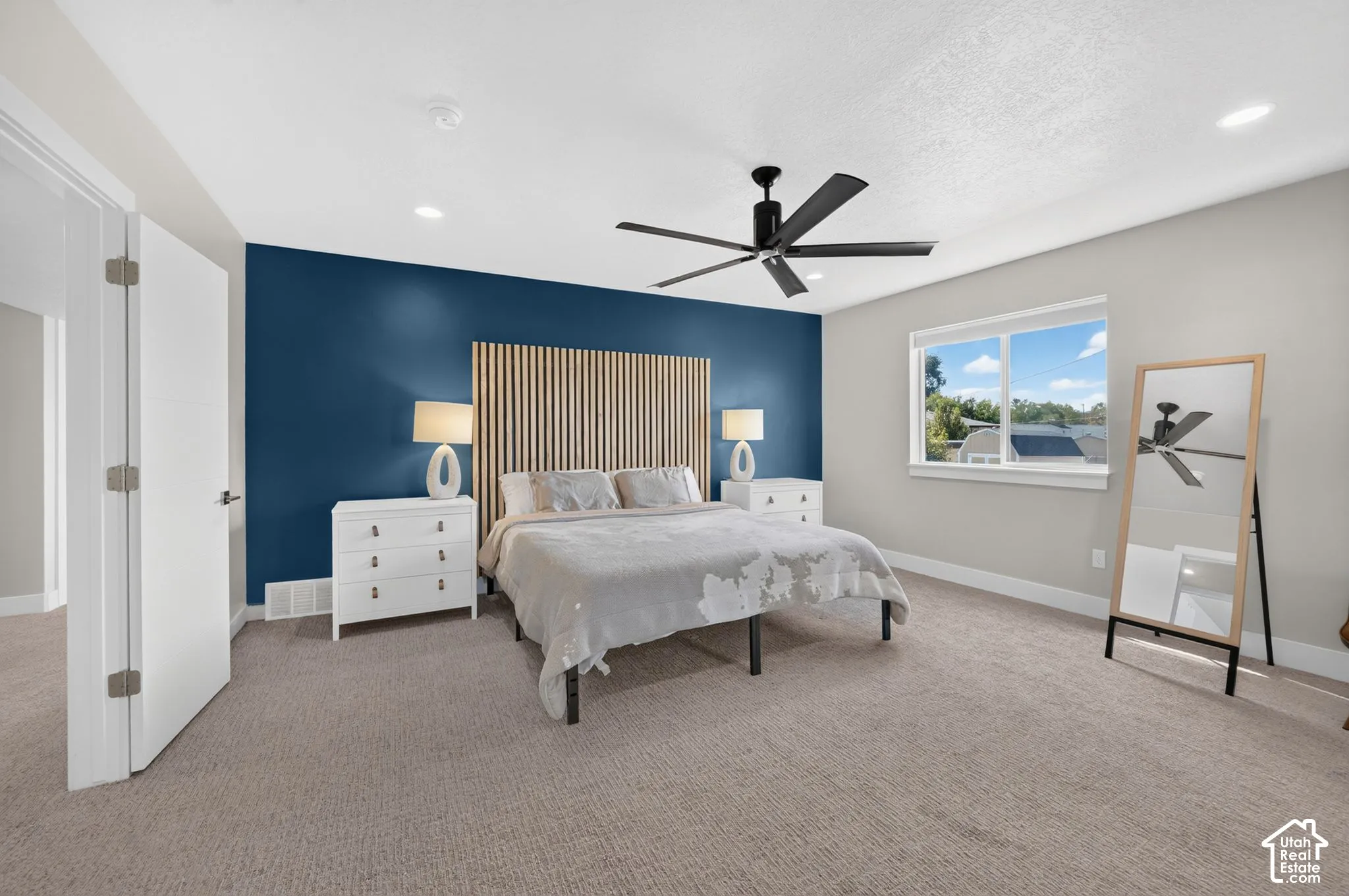 Spacious master suite with recessed lighting, ceiling fan and west facing windows