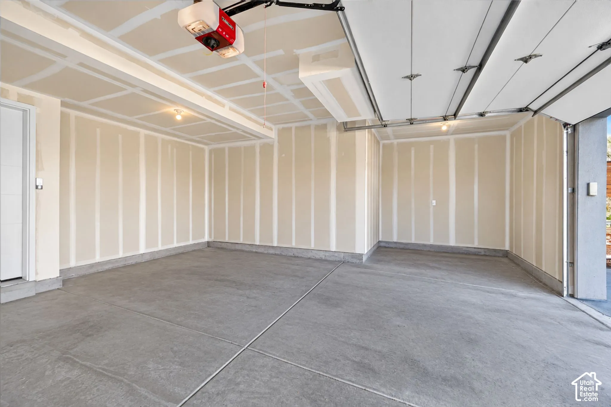 Attached two-car garage. Digitally altered to remove cars and packing boxes.