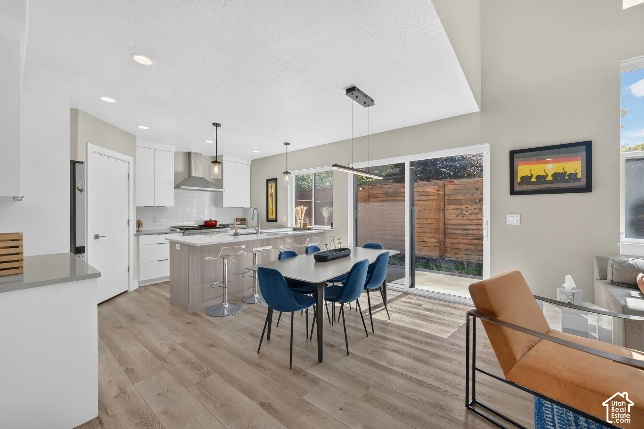 Open-concept kitchen and dining area with sliding glass door access to private backyard