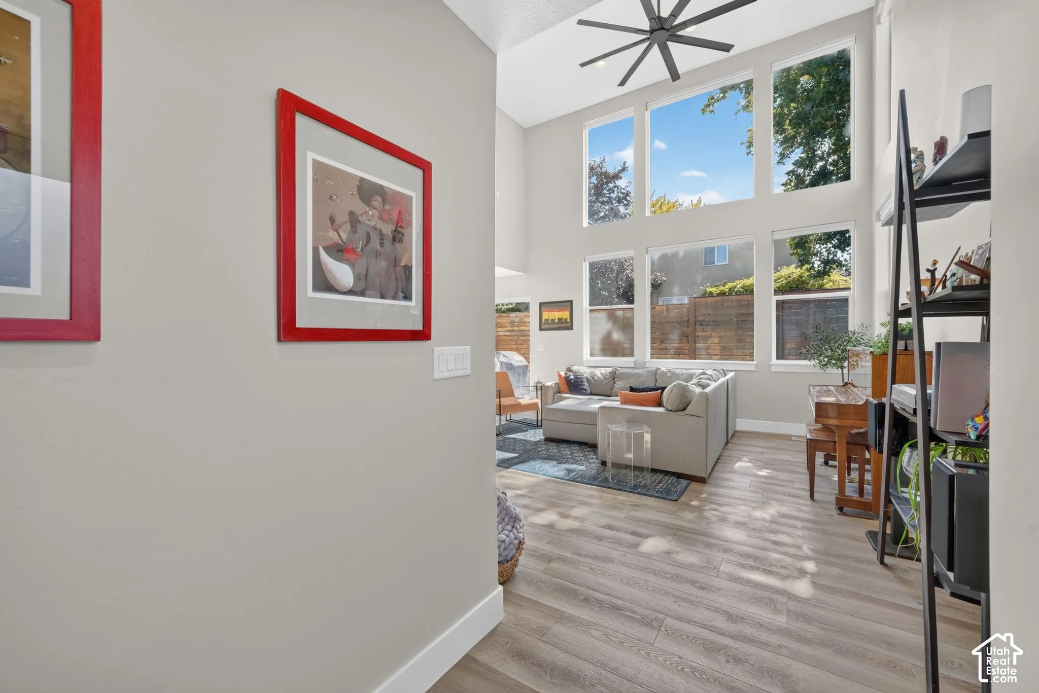 View from foyer into open-concept living space with expansive two-story windows