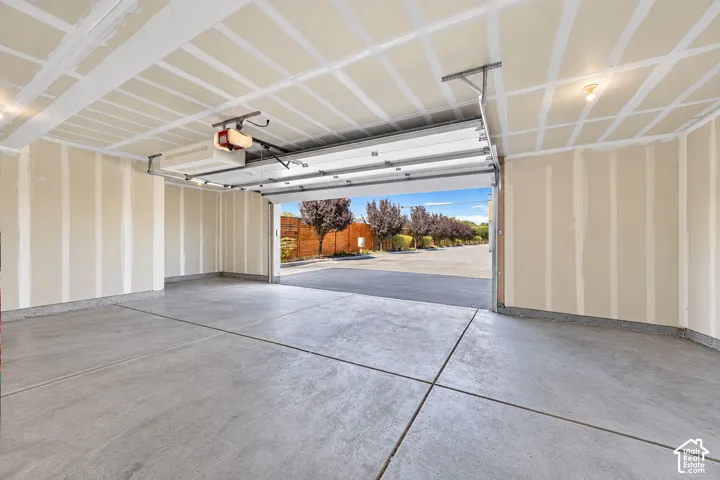 Spacious 2-car garage with extra room for storage. Digitally altered to remove cars and packing boxes