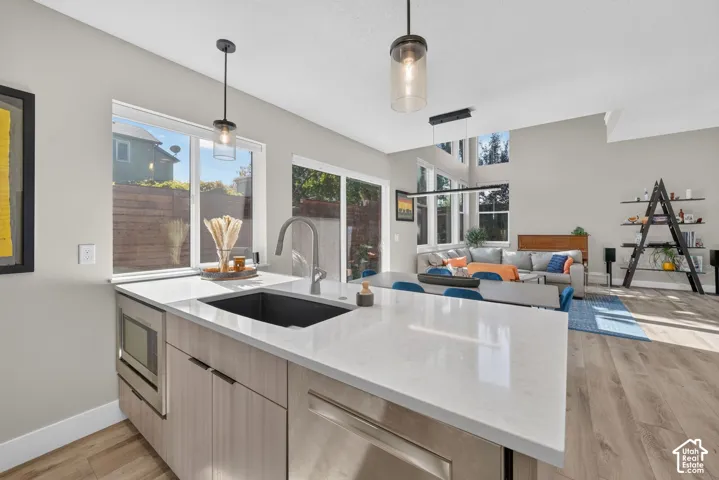 Kitchen island with a built-in sink and stainless steel appliances