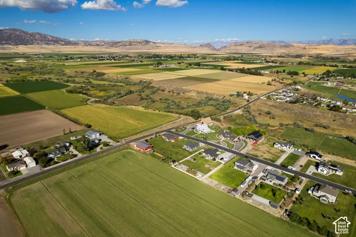 Expansive rural landscape featuring agricultural fields and distant mountainous terrain