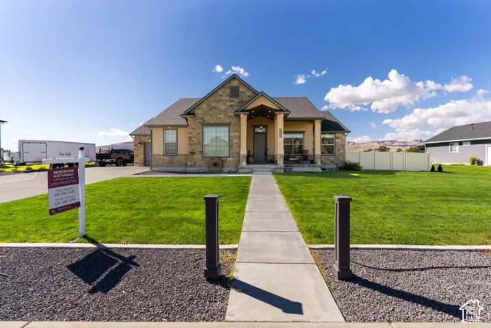 Stone and stucco exterior with an inviting covered porch