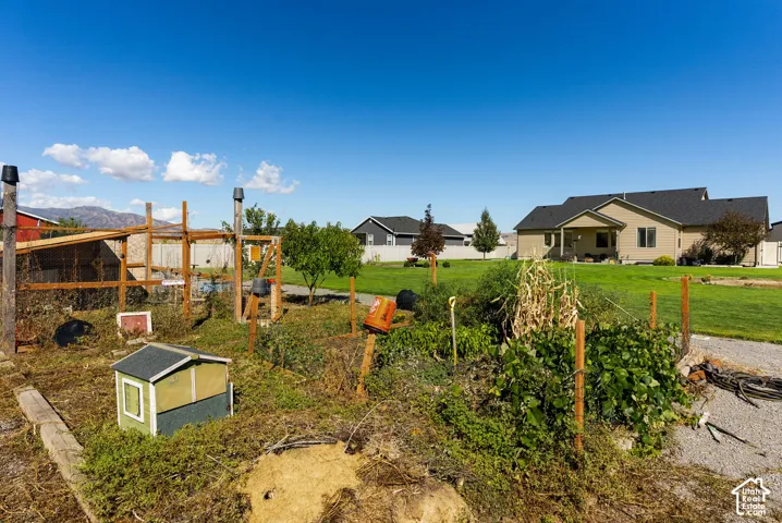 Cultivated garden area with established plantings and a built-in wooden structure