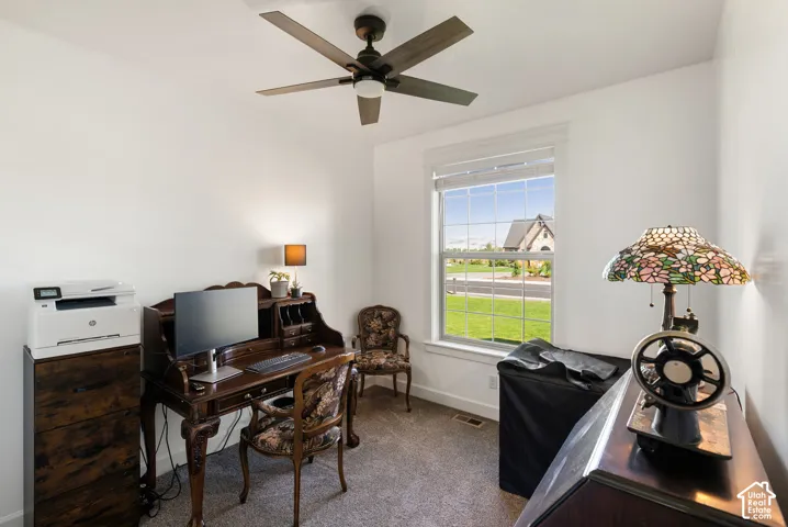 White walls with a ceiling fan, a window with horizontal blinds, and carpeted flooring