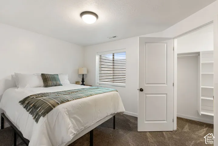 White walls with a textured ceiling and recessed lighting