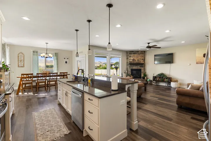 Kitchen island featuring a double-basin sink and stainless steel dishwasher