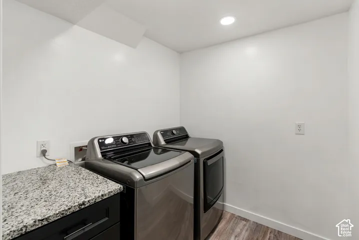 Recessed ceiling lighting, wood-finish flooring, granite-look countertop, and built-in cabinetry