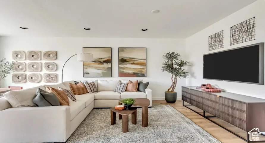 Recessed lighting, wood-finish flooring, white walls, and a built-in media consoles. This home is under construction. Pictures are of a similar home