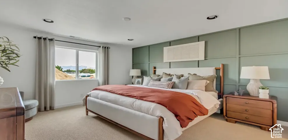 Bedroom featuring a paneled accent wall, recessed lighting, and a large windows. This home is under construction. Pictures are of a similar home