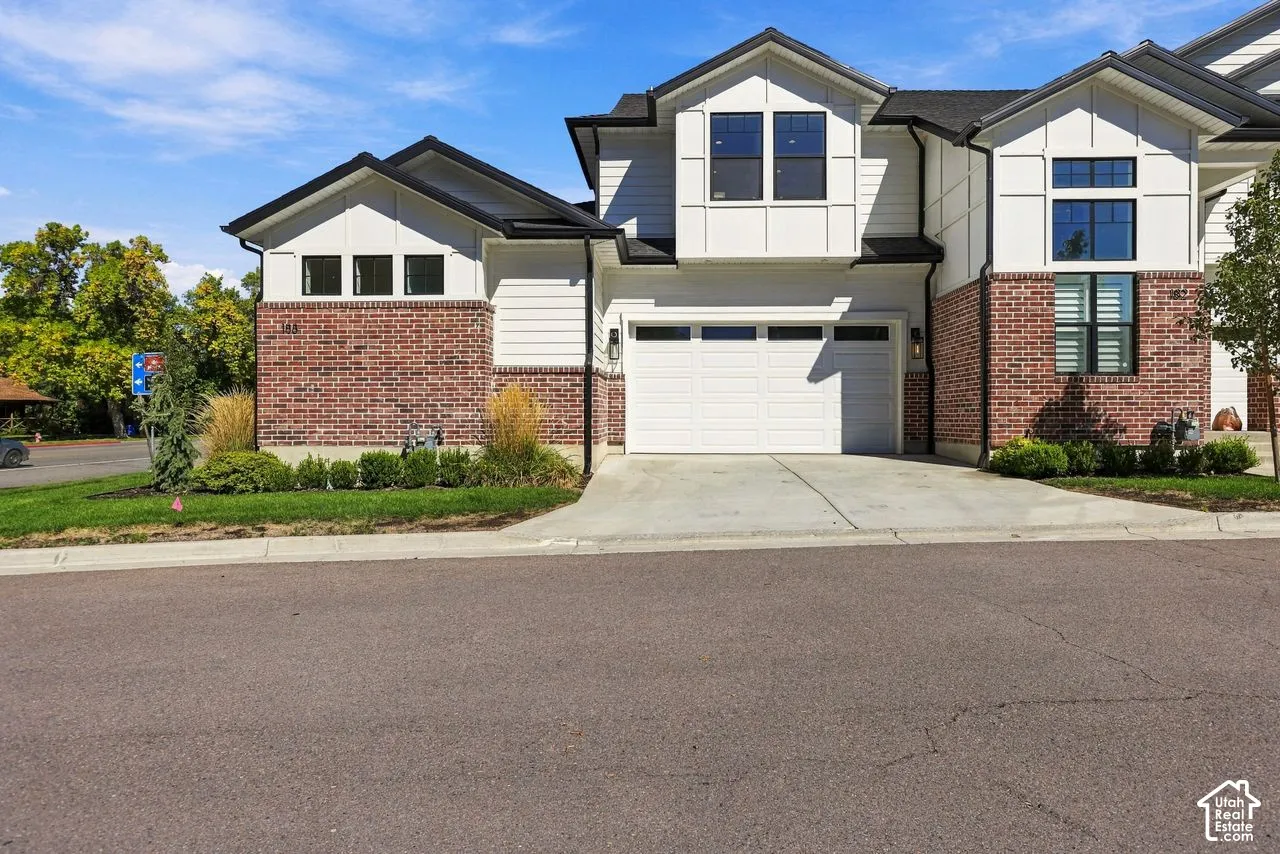 3 Level townhome with 2 car garage, main level primary suite and an end unit