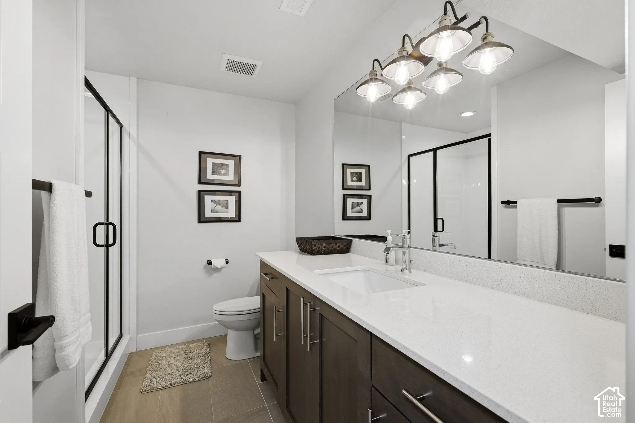 Lower level hall bath with large vanity and step in shower