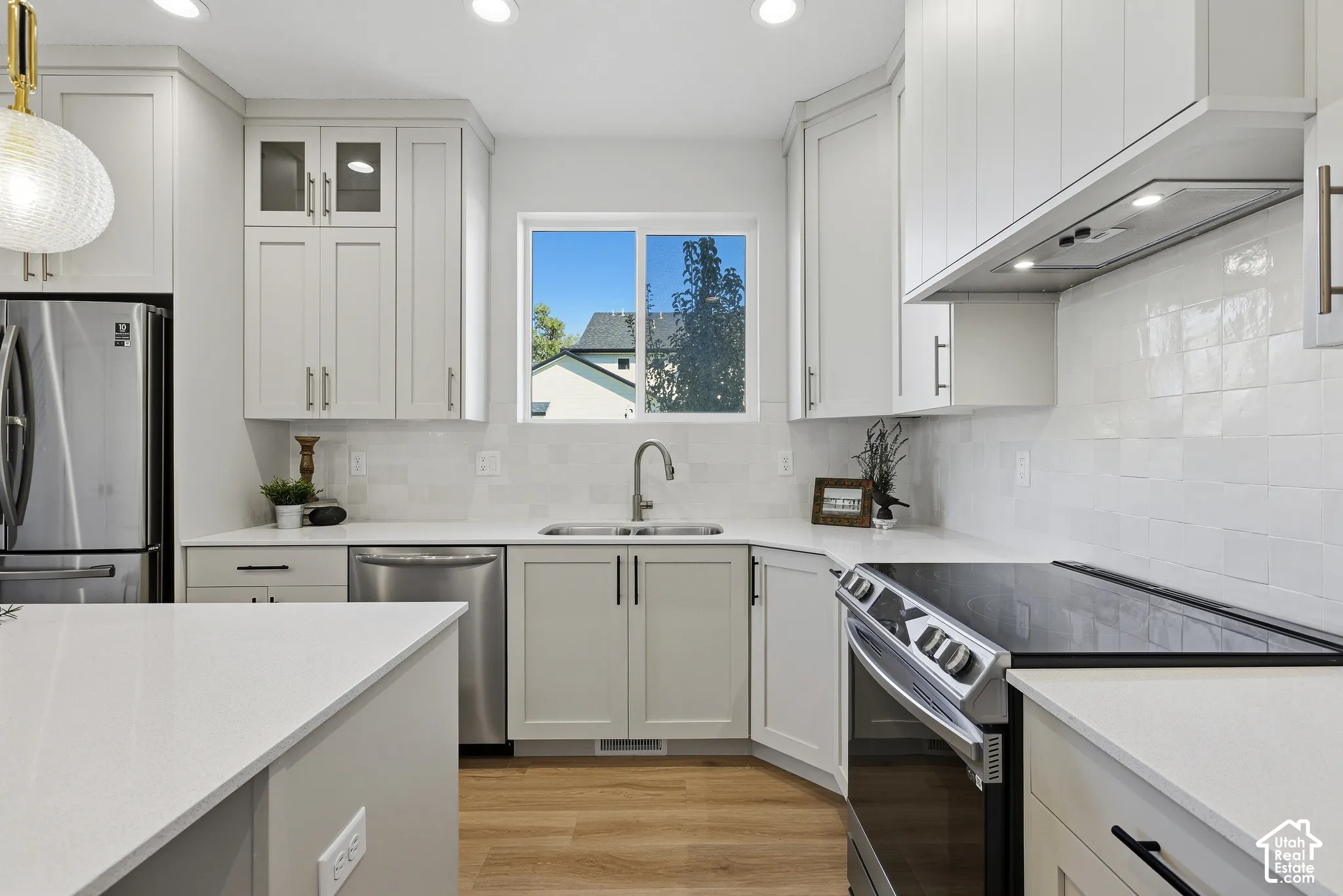 Gourmet kitchen with quartz countertops, stainless steel appliances, center island and large pantry