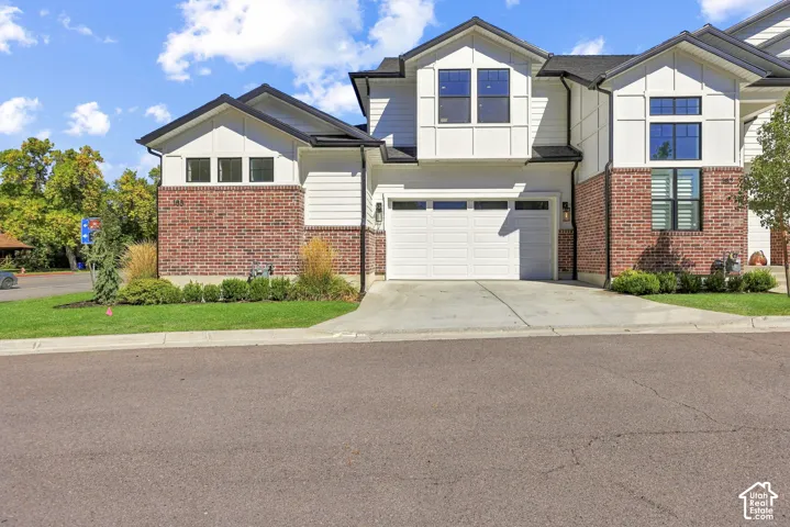 End row townhome with a main floor primary suite, plus a 2 car attached garage