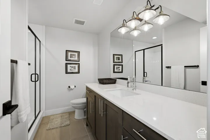 Lower level hall bath with large vanity and step in shower