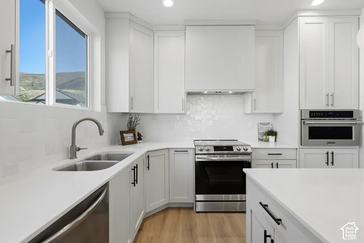 Gourmet kitchen with quartz countertops, stainless steel appliances, center island and large pantry