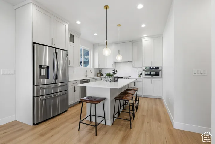 Gourmet kitchen with quartz countertops, stainless steel appliances, center island and large pantry