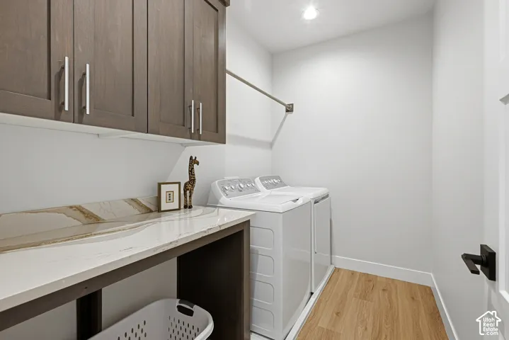 Main floor laundry room with large counter for folding and cabinets for storage