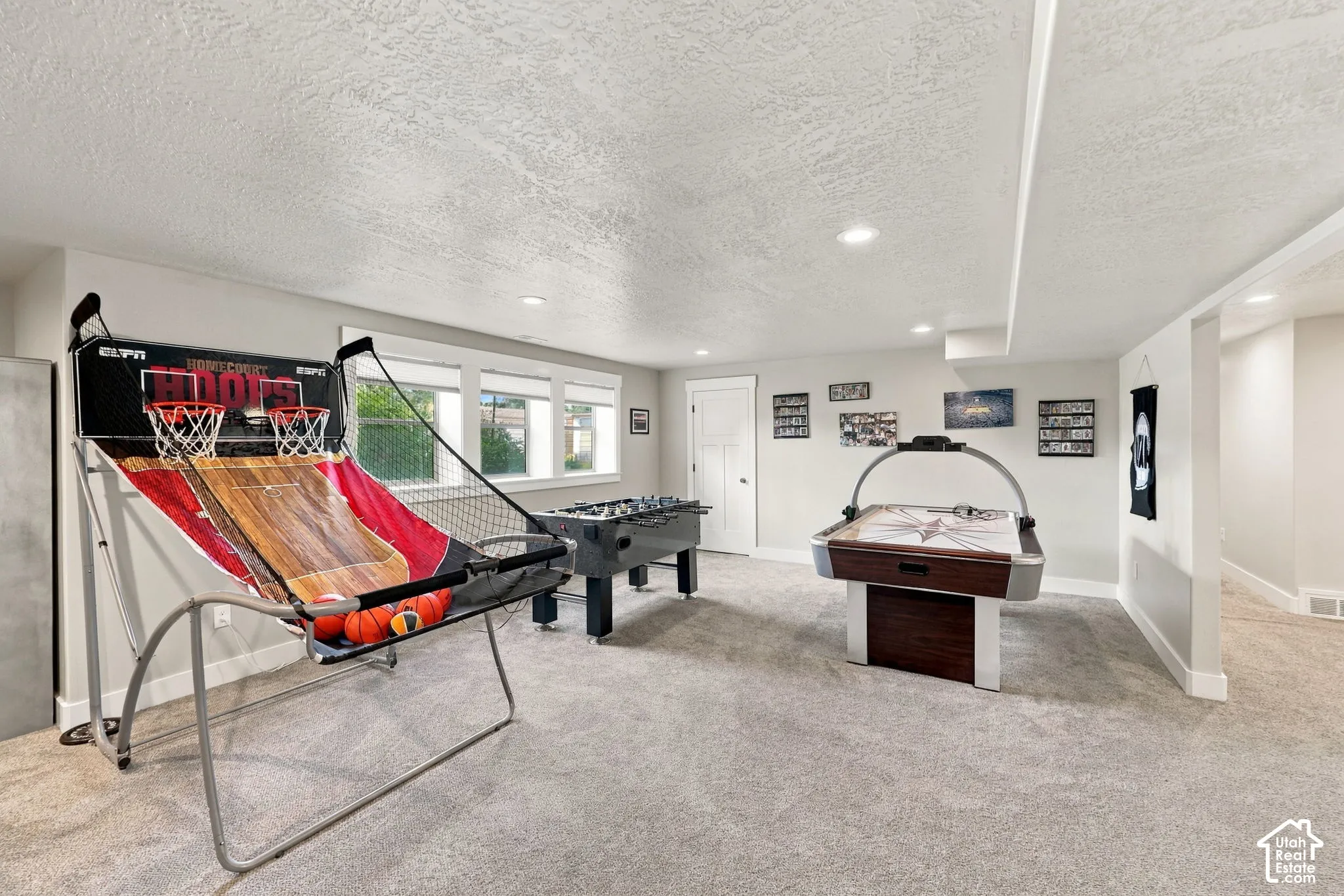 Recessed lighting, light-toned walls, and carpet flooring