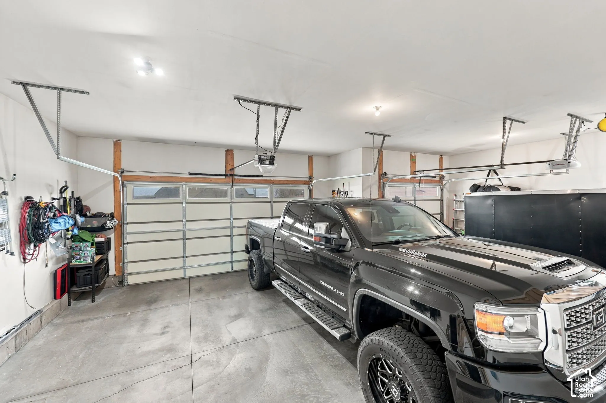 Spacious garage featuring concrete flooring and multiple overhead garage doors with integrated window panels