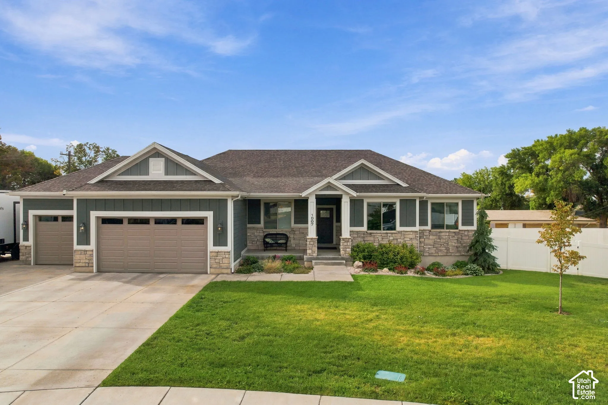 Exterior featuring stone accents, horizontal siding, and a gabled roofline