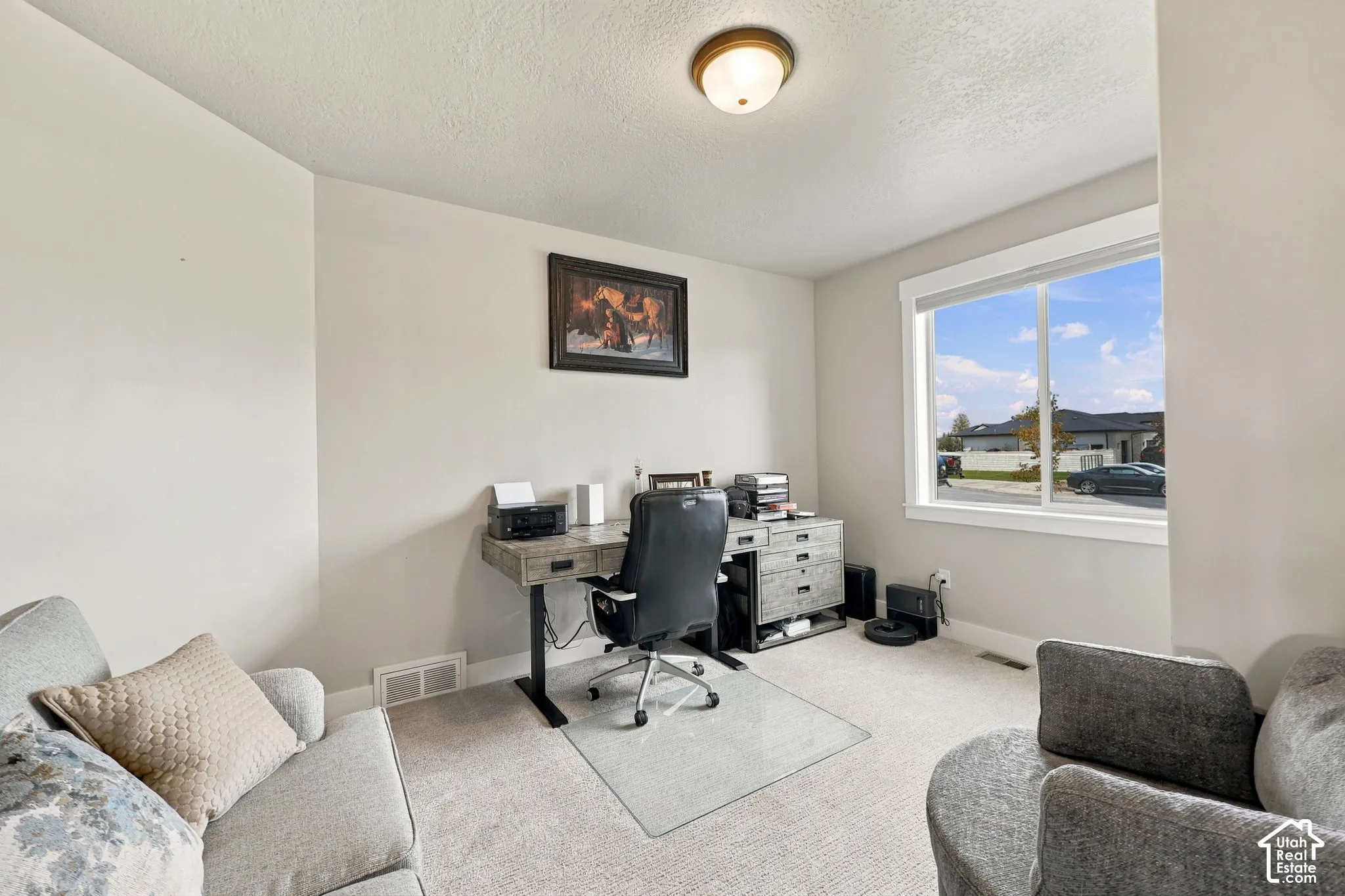 Recessed ceiling light, large window, neutral wall paint, carpet flooring