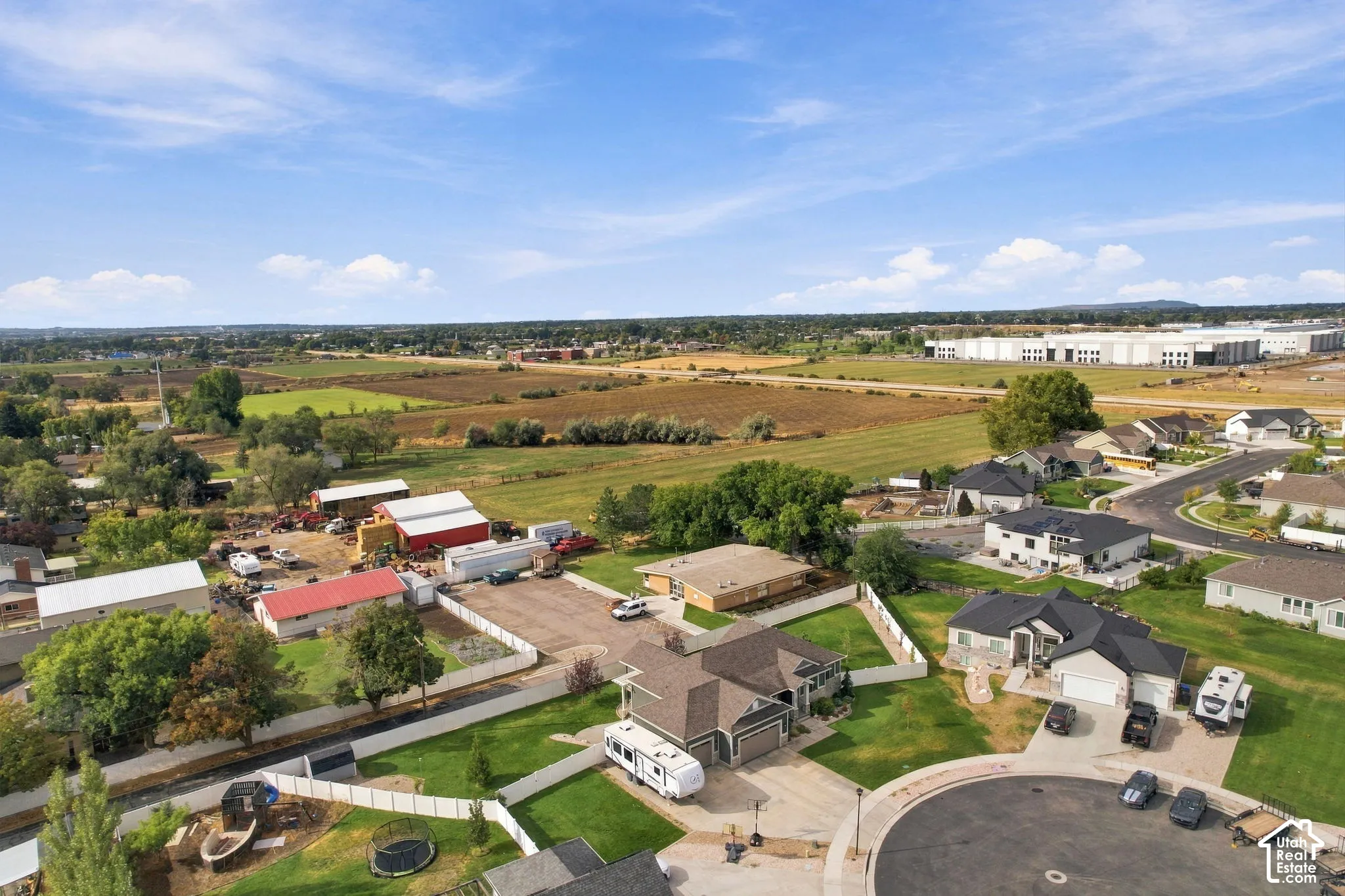 Residential properties with paved streets and surrounding agricultural land