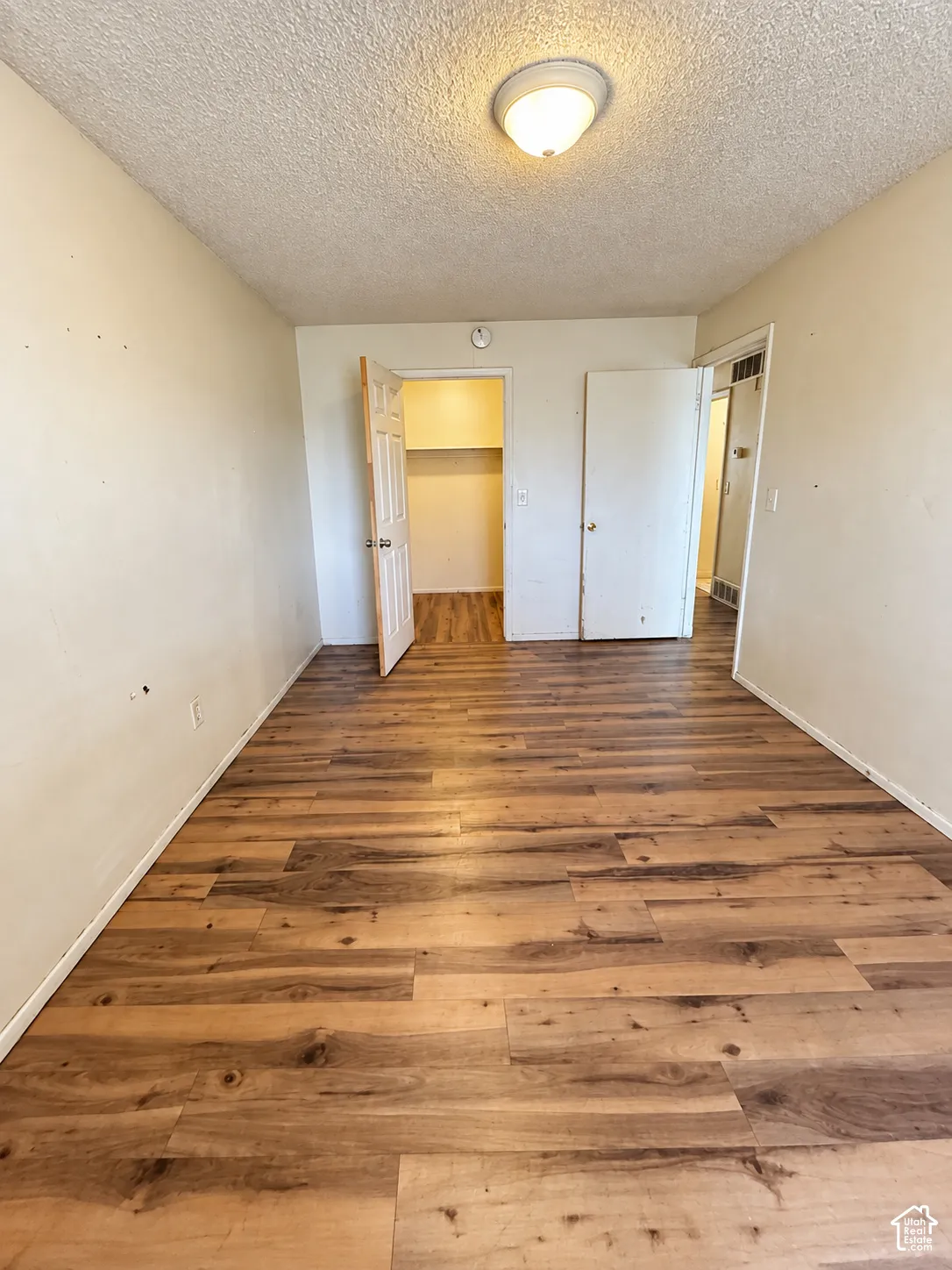 Wood-finish flooring throughout, with a built-in closet featuring shelving