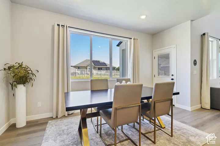 Recessed lighting, wood-finish flooring, and a glass-panel exterior door