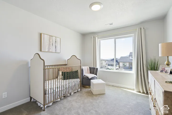 Recessed lighting, large window, neutral wall paint, light-colored carpeting, window treatments