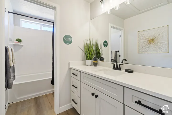 Dual-sink vanity with white cabinetry, matte black hardware, and a white countertop