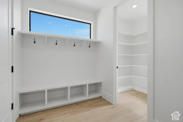 Built-in bench seating with cubby storage, upper shelf, and coat hooks