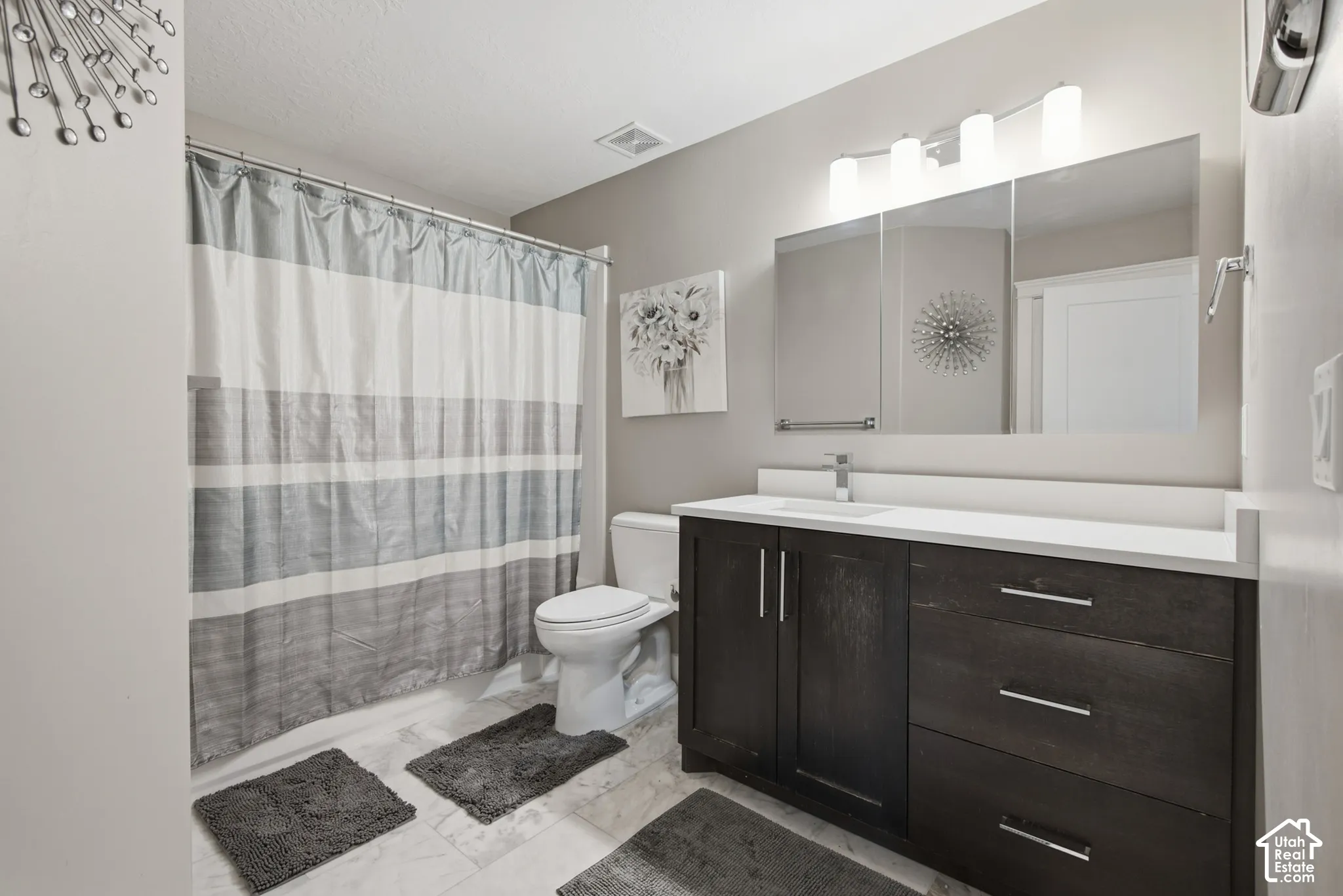 Dark wood-finish vanity with a white countertop and integrated sink