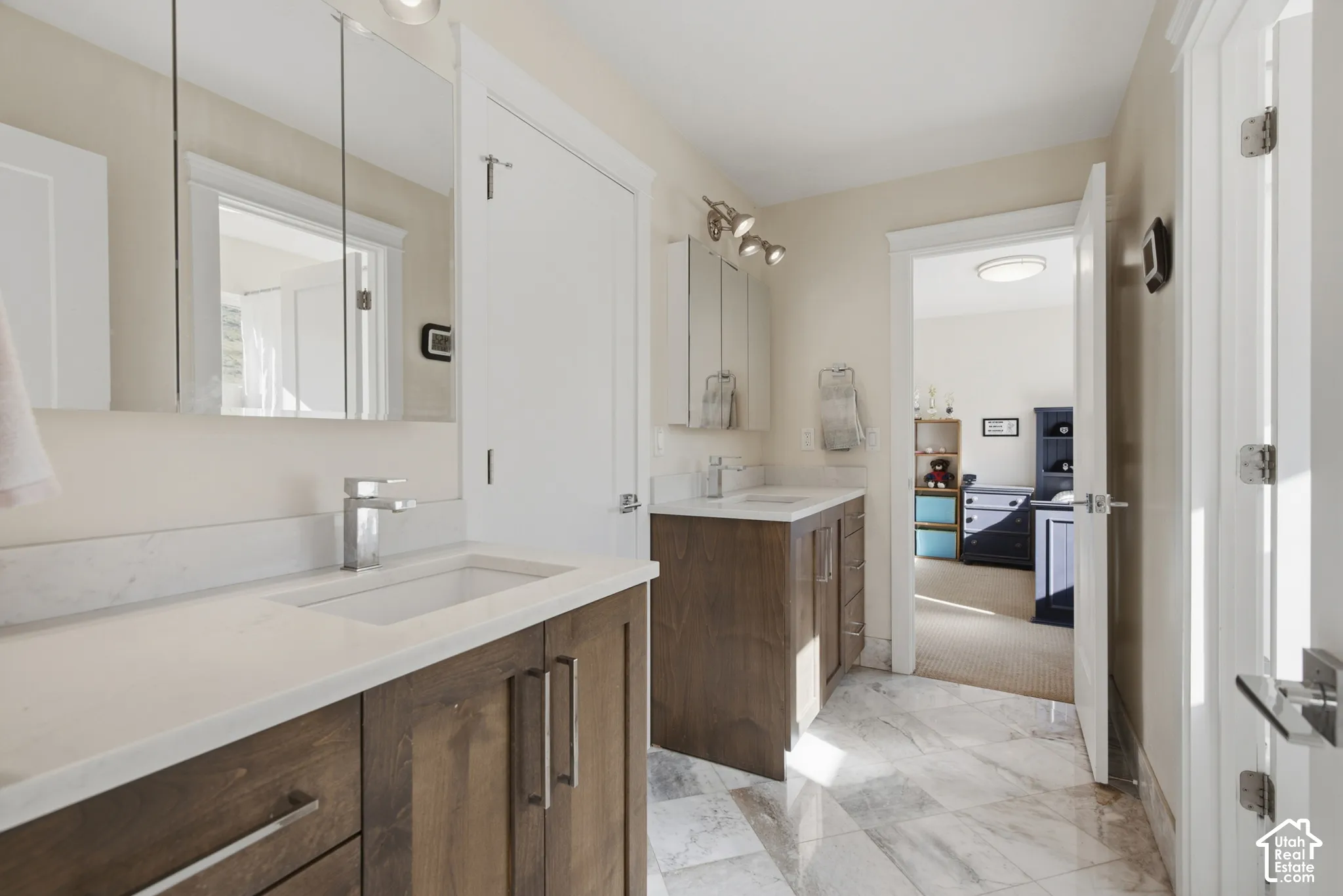 Dual vanity with wood-finish cabinetry and light-toned countertops