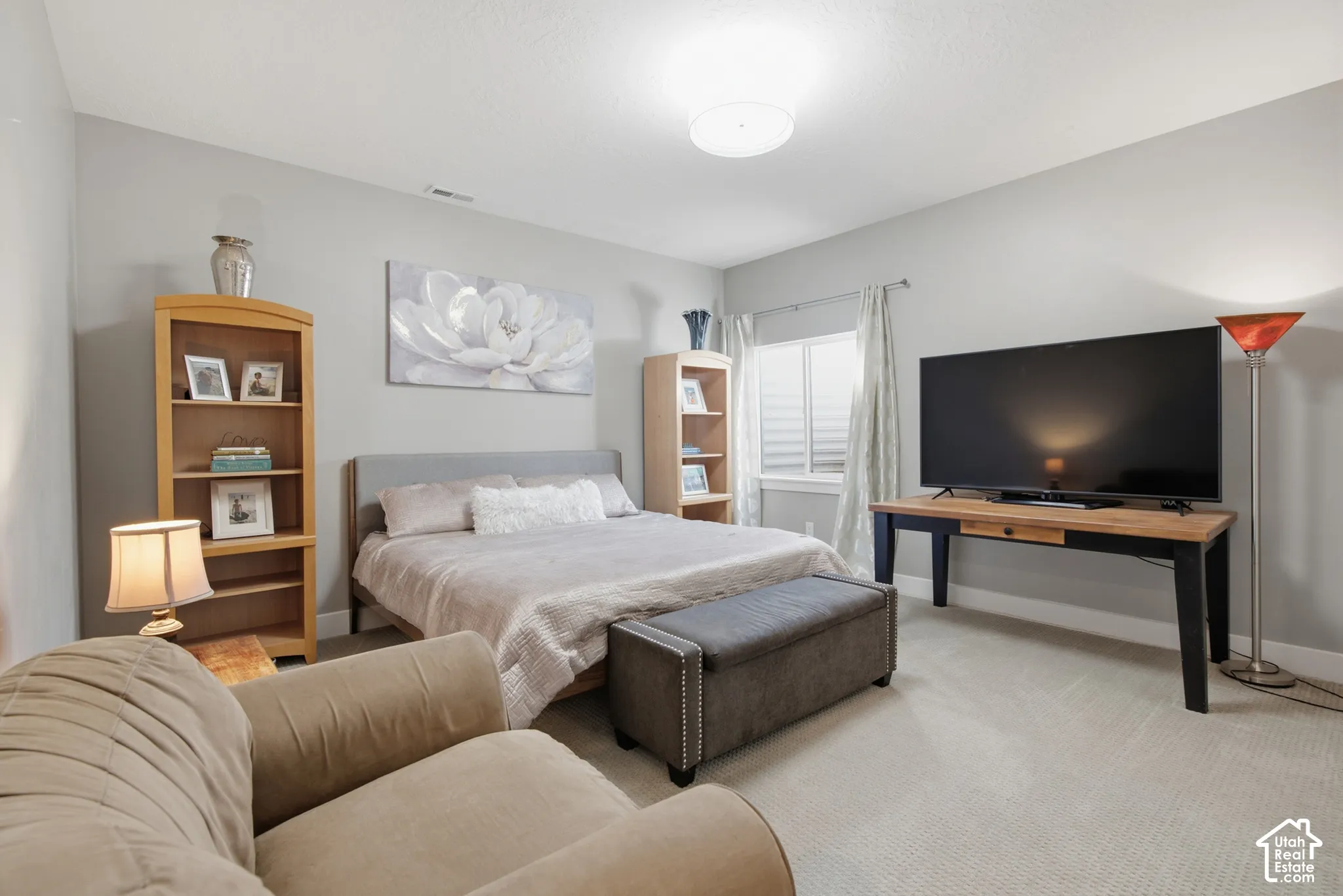 Neutral-toned walls complement the carpeted flooring