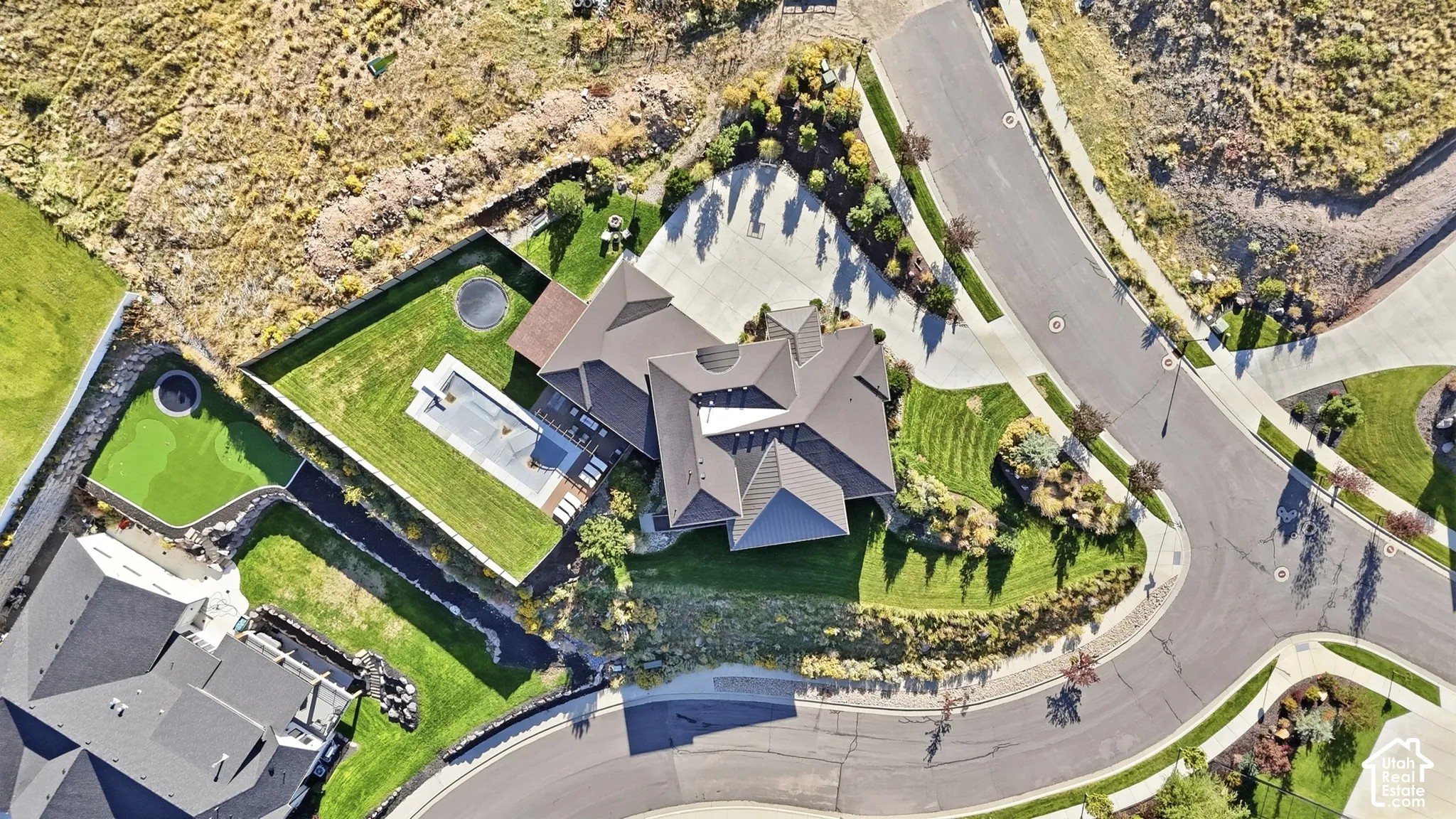 Expansive property featuring a multi-level roofline, extensive driveway, and manicured lawns