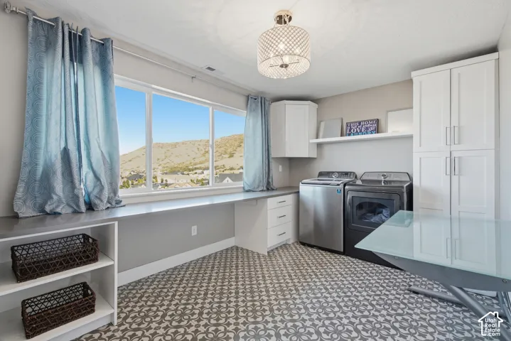 Expansive window wall, patterned flooring, built-in cabinetry, recessed lighting, and a linear countertop