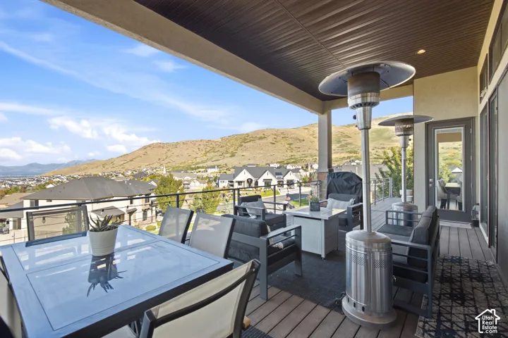 Covered outdoor patio with wood-finish decking and dark railing