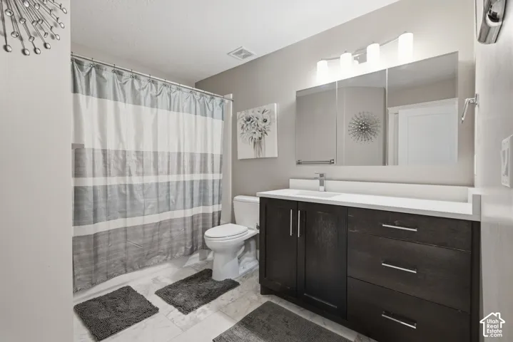 Dark wood-finish vanity with a white countertop and integrated sink