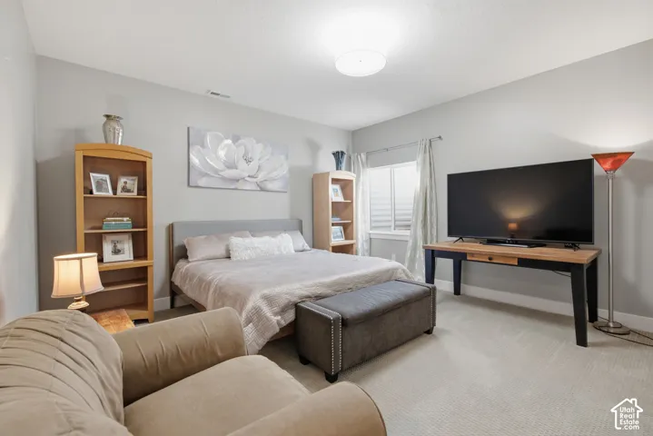 Neutral-toned walls complement the carpeted flooring