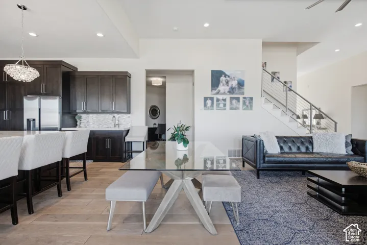 Open-concept living space featuring wood-finish flooring and recessed lighting