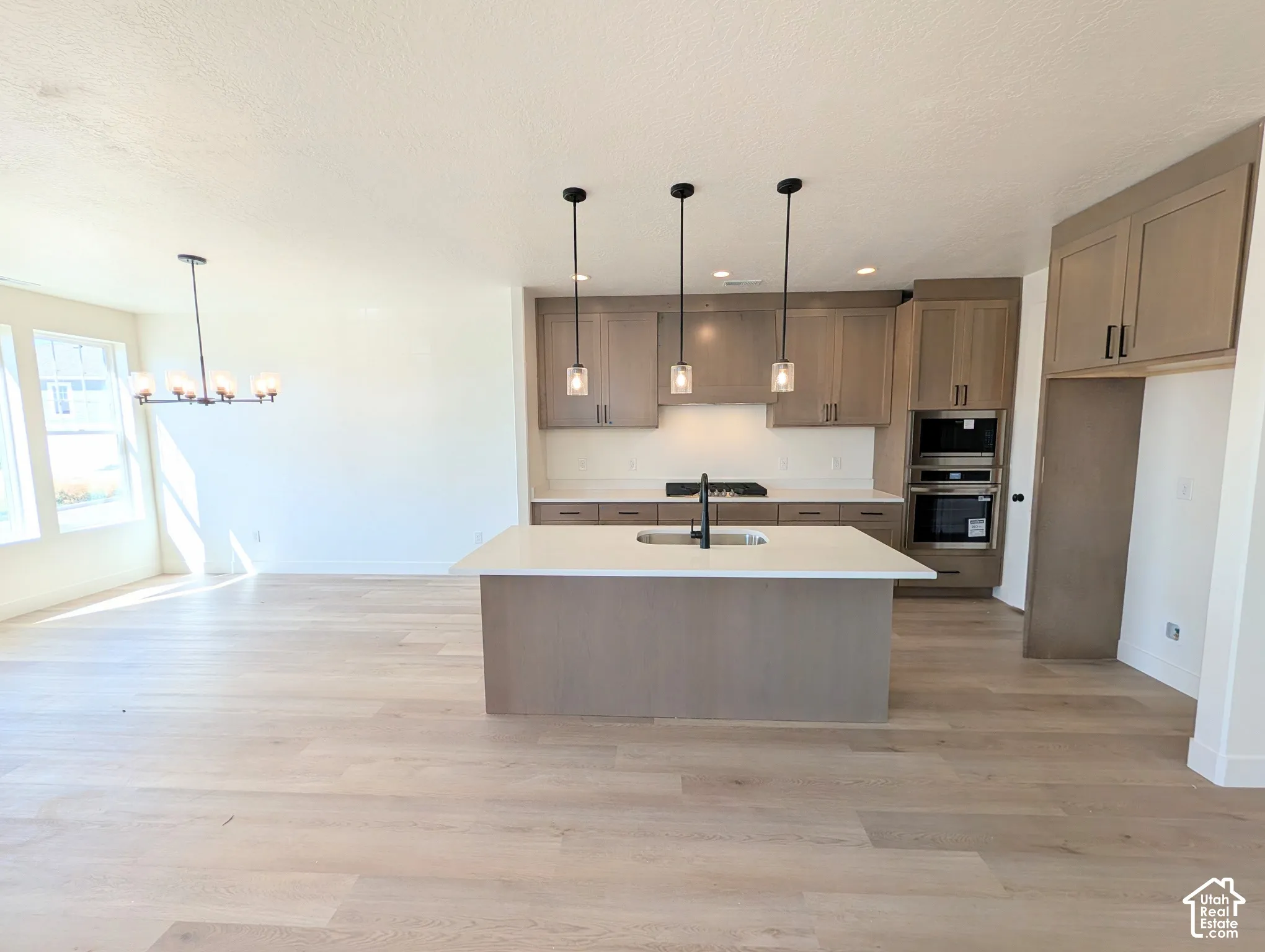 Spacious open-concept layout with light wood-finish flooring