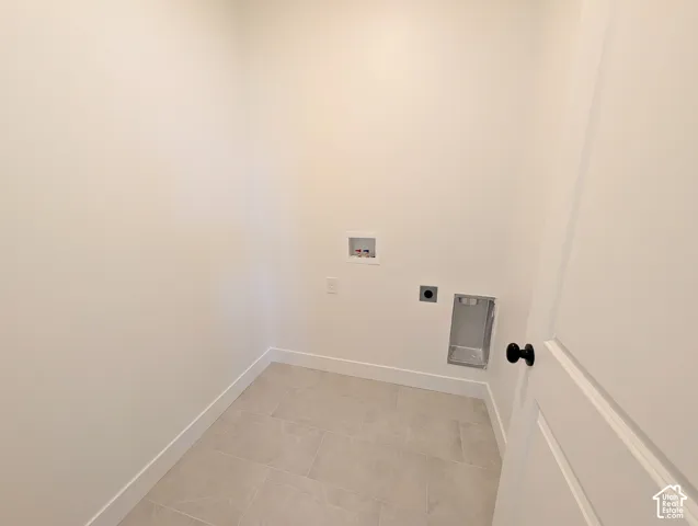 White interior walls with light-toned rectangular floor tiles